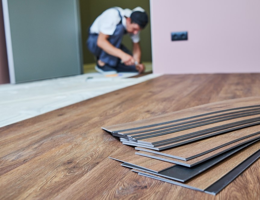 Flooring work. worker joining vinyl floor covering at home renovation Residential Flooring